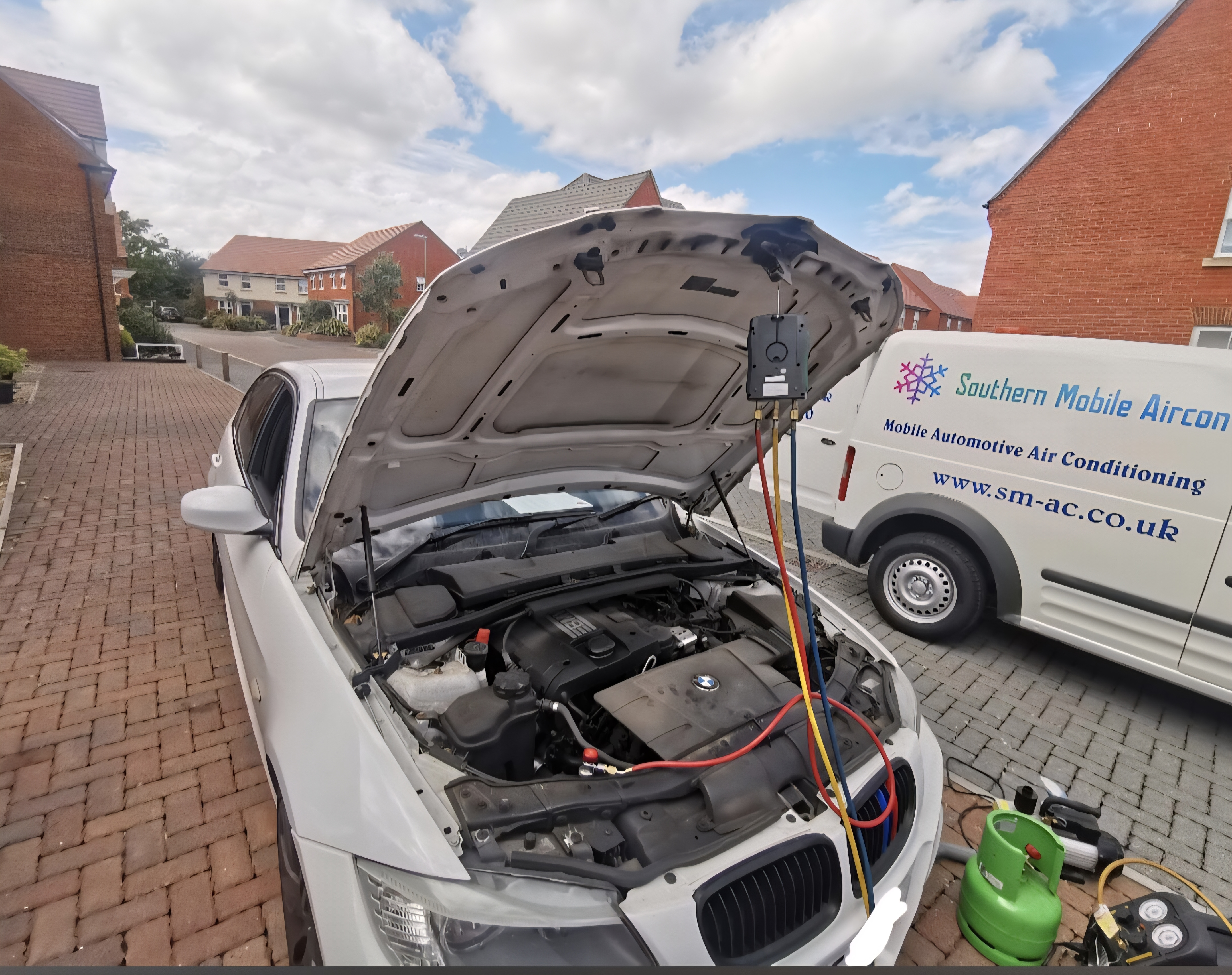 White BMW AC recharge with Southern Mobile Aircon van in background