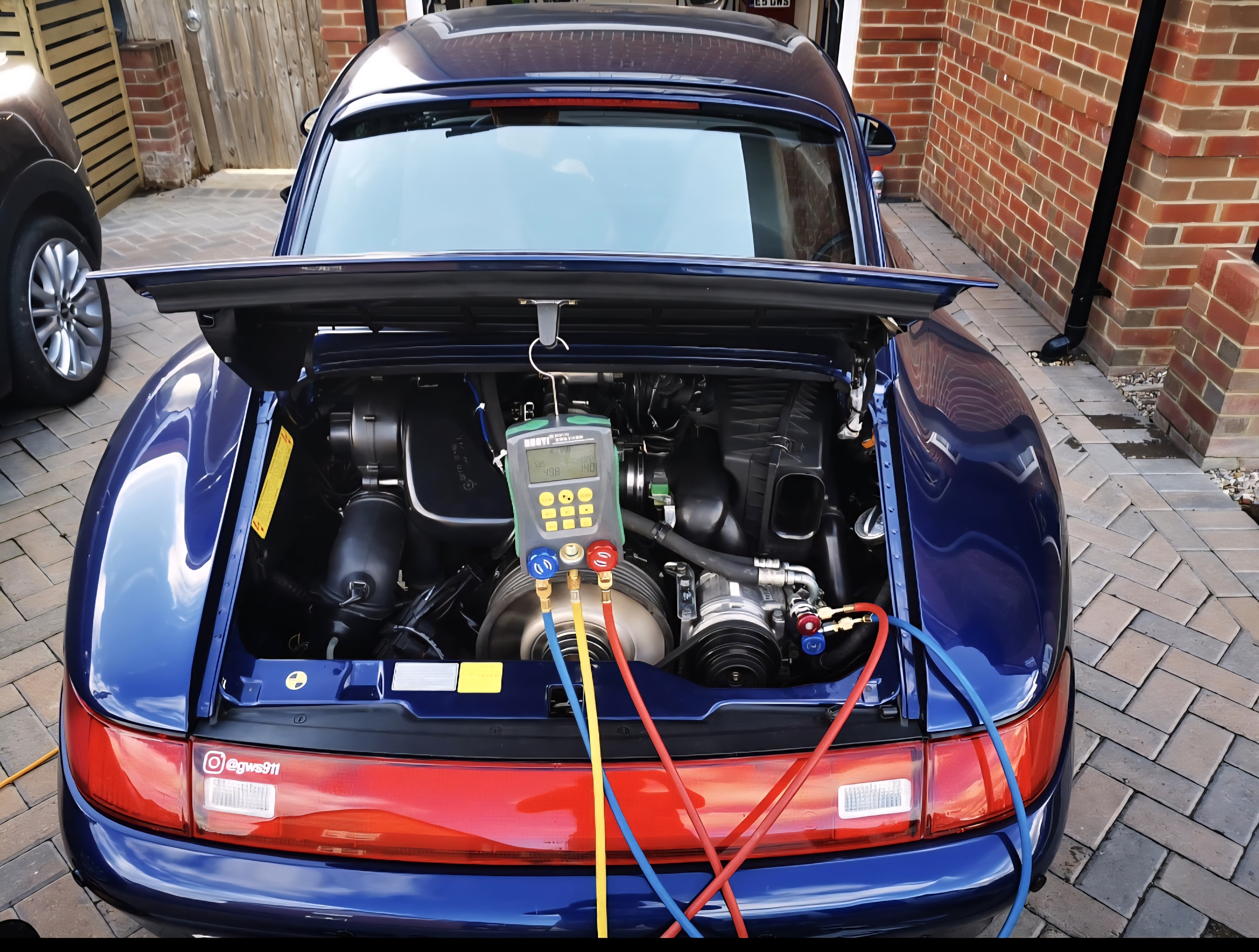 Porsche 911 rear-engine AC service with manifold gauges connected